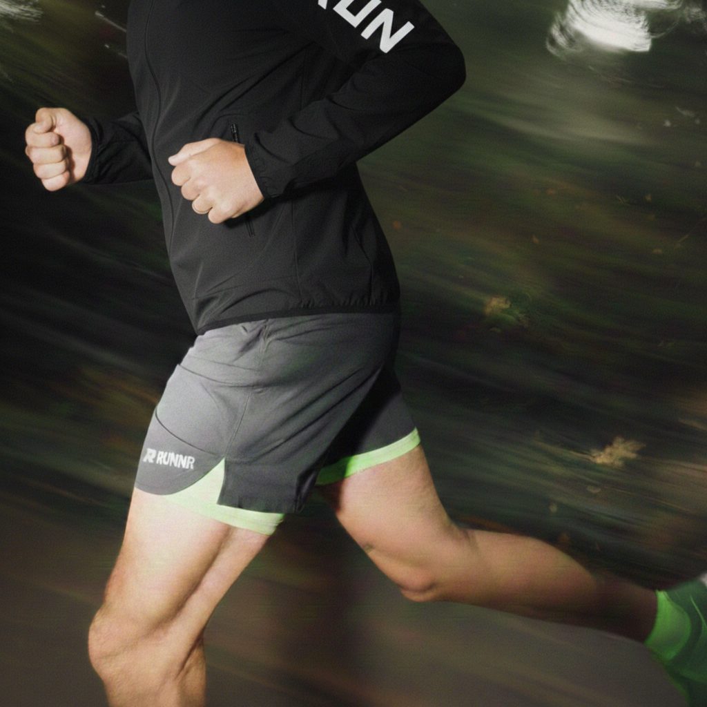 Runner in RUNNR gear moving at speed through the dark
