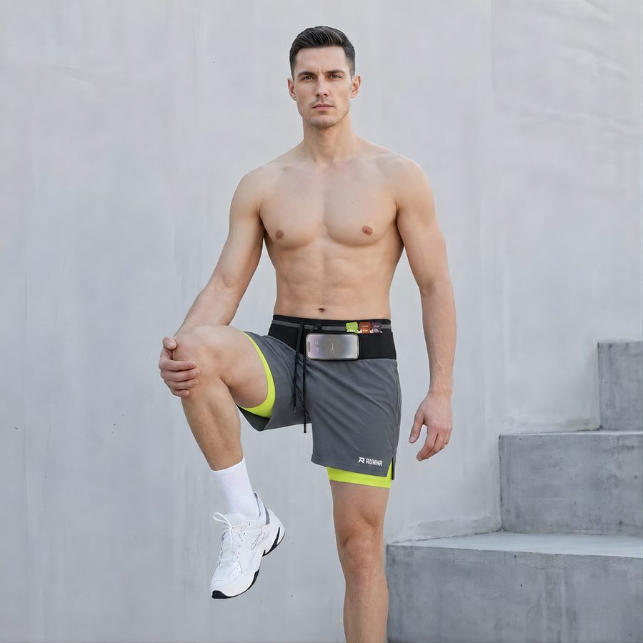 Man in RUNNR Marathon Pro Shorts on concrete steps
